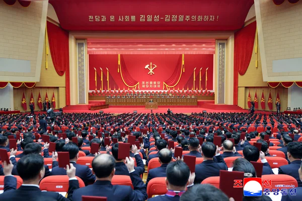 Kim Jong Un speaking at a podium with the official Workers' Party emblem during the congress.