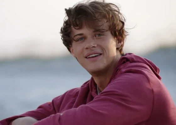 Split screen of Christopher Briney and Lukas Gage with a snowy backdrop.