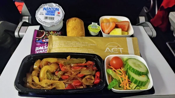 Premium economy meal by chef Frédéric Simonin served on Air France flight with scallops and pasta