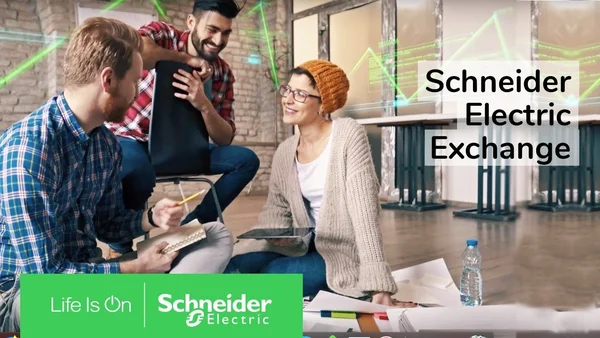 Groupe de trois collaborateurs en session de travail informelle sous le logo 'Life Is On Schneider Electric' et la mention 'Schneider Electric Exchange'.
