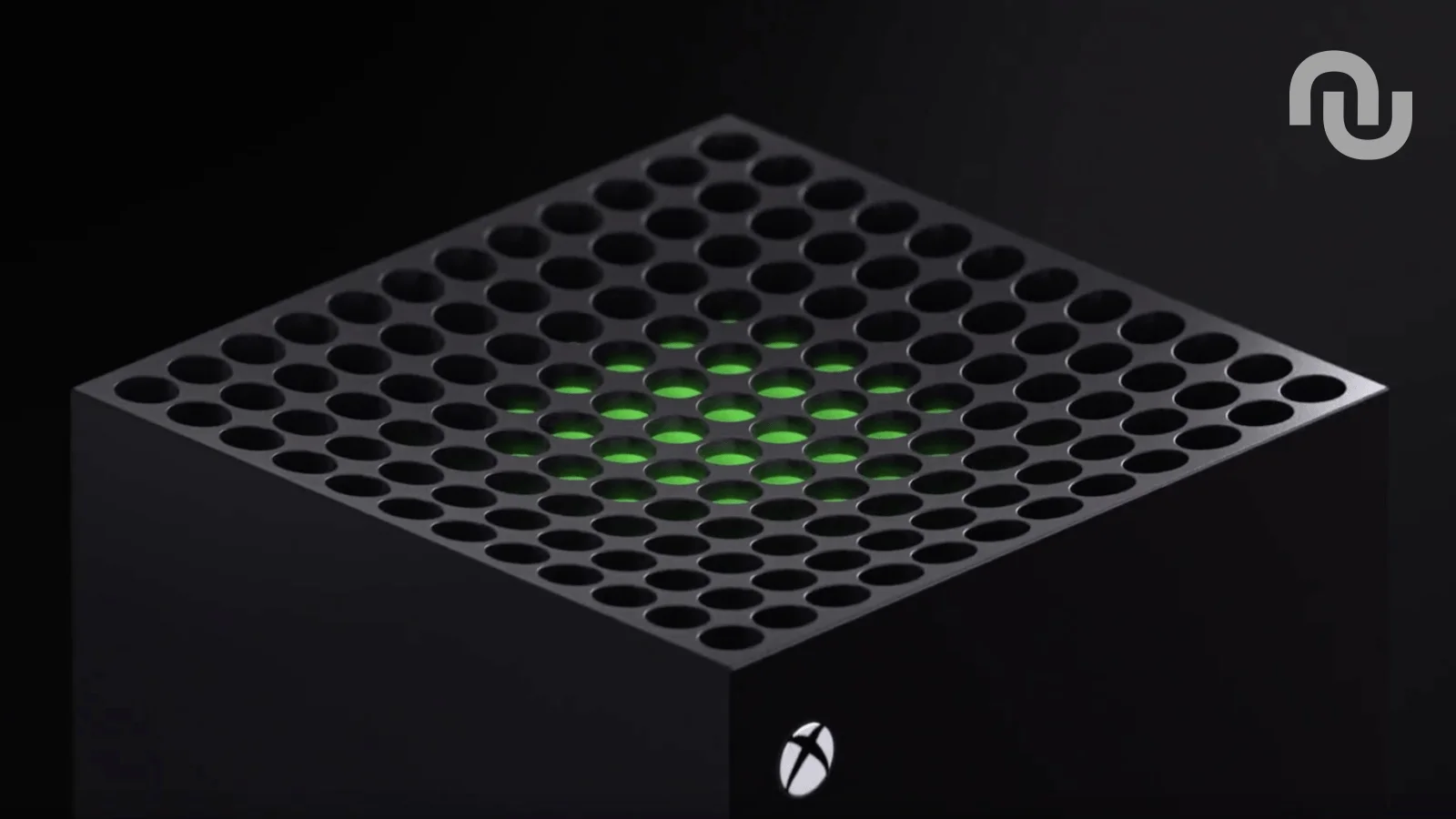 Surface de console Xbox avec grille perforée et lumières vertes au centre.