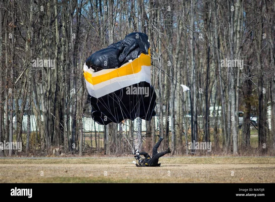 Parachutiste lors d'un atterrissage difficile sur un terrain herbeux.