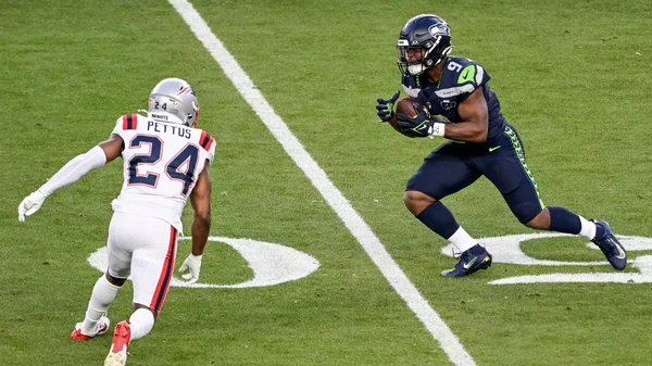 Action de jeu entre les Seahawks et les Patriots lors d'un match NFL.