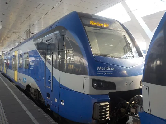 Un train Meridian à quai sous l'auvent moderne de la gare de Salzbourg.