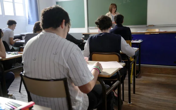 Épreuve du bac français au lycée Janson de Sailly à Paris : des élèves en classe avec leur professeur.