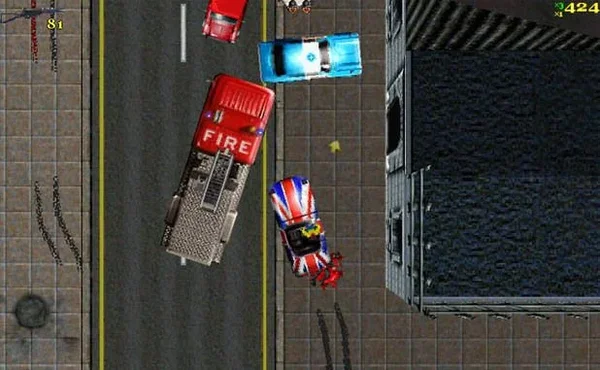 A top-down screenshot from the video game Grand Theft Auto: London 1969, showing a chaotic street scene with multiple vehicles including a red fire truck and a car decorated with the Union Jack flag.