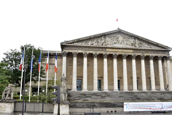 Le Palais Bourbon, siège de l'Assemblée nationale, avec les drapeaux français à gauche.