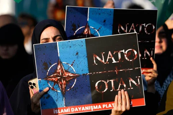 Manifestante brandissant une pancarte anti-OTAN lors des protestations à Ankara.